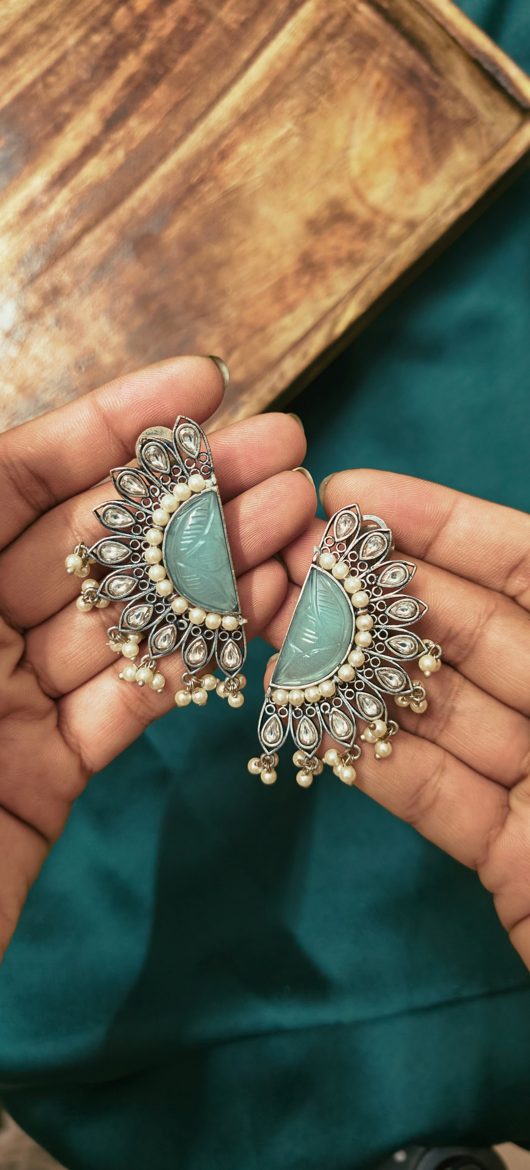 OZEL OXIDISED SILVER PLATED WITH CARVED MINT GREEN STONE STUDED WITH PEARLS AND KUNDAN EAR STUDS